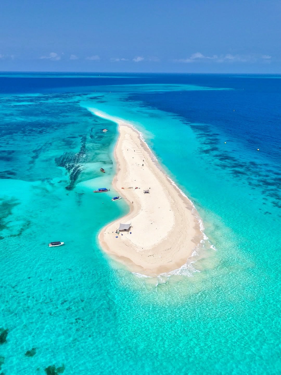 Aerial view of a pristine sandbar surrounded by turquoise Zanzibar waters